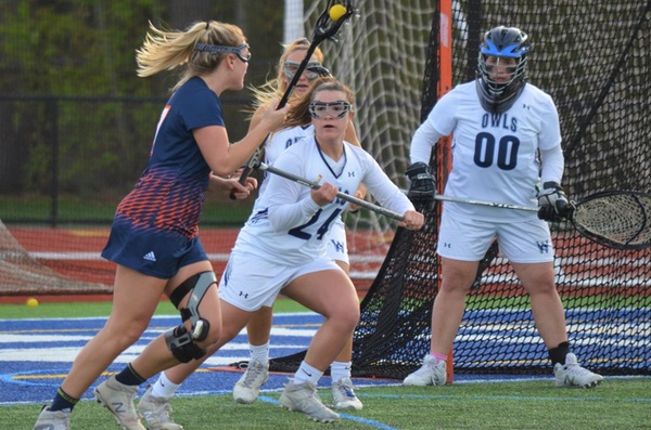 Caroline Arket, Lily Howes and goalkeeper Maria Woodall protect the net in a 17-2 win over Salem State in the MASCAC quarterfinals.