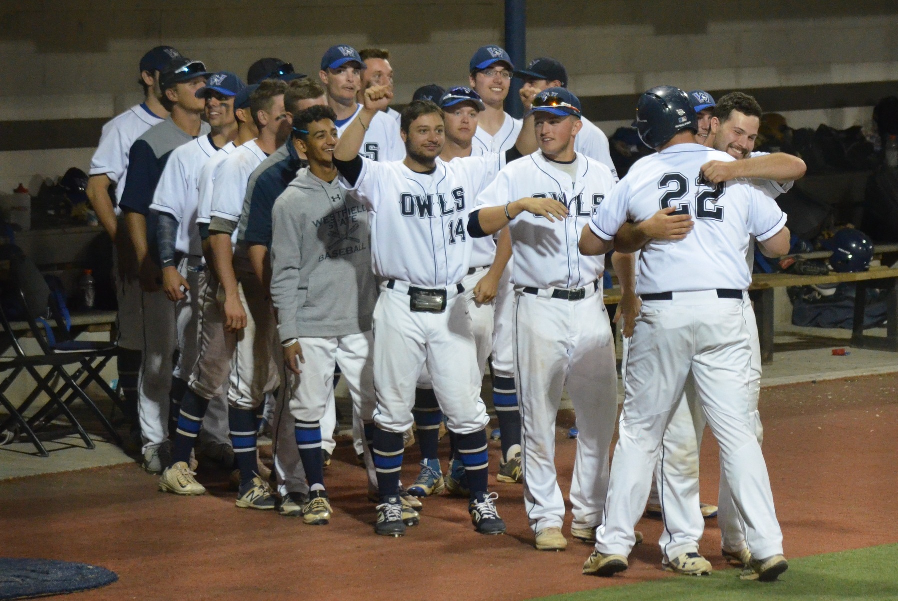 Westfield State senior pitcher John Gegetskas (22) gets a hug from Jake Gibb and is cheered by his teammates after being lifted for a pinch runner after Gegetskas walked in his only career plate appearance in the ninth inning against Shenandoah in the NCAA Tournament.
