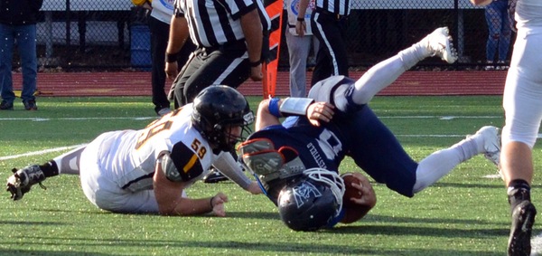 Westfield's Jake Cassidy is tackled by Framingham's Cam Powers